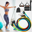 Woman exercising with resistance bands and accessories on a white background