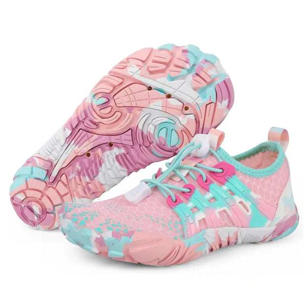 Pair of pink and blue water shoes on a white background