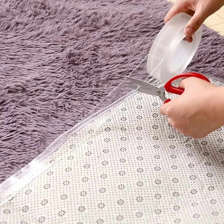 Person cutting clear tape with scissors on a textured surface