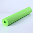Green yoga mat rolled up on a light gray background