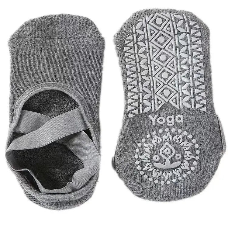 Gray yoga socks with patterned sole and brand logo on a white background