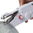 Handheld sewing machine in use on a piece of fabric with a white background