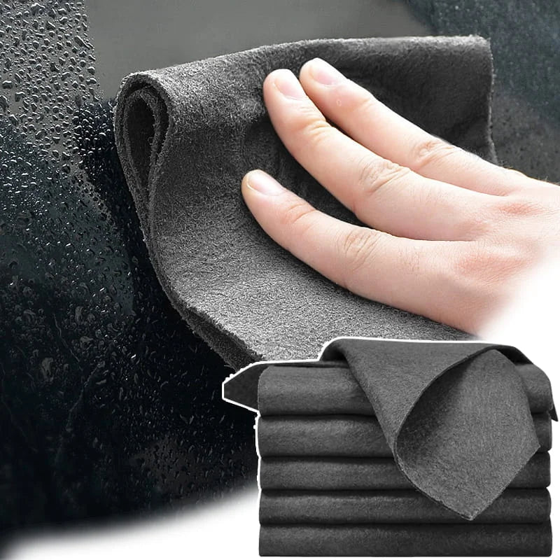 Gray microfiber cloth being used to clean a car window with a hand, and a stack of similar cloths below.