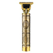 Gold and bronze hair trimmer with intricate design on a white background