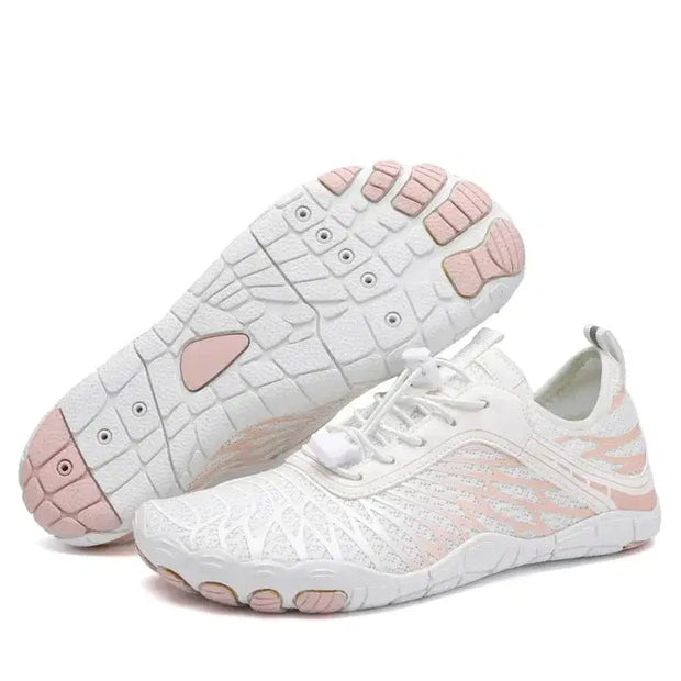 White sneakers with pink soles on a white background