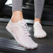 Person wearing white athletic shoes on a treadmill