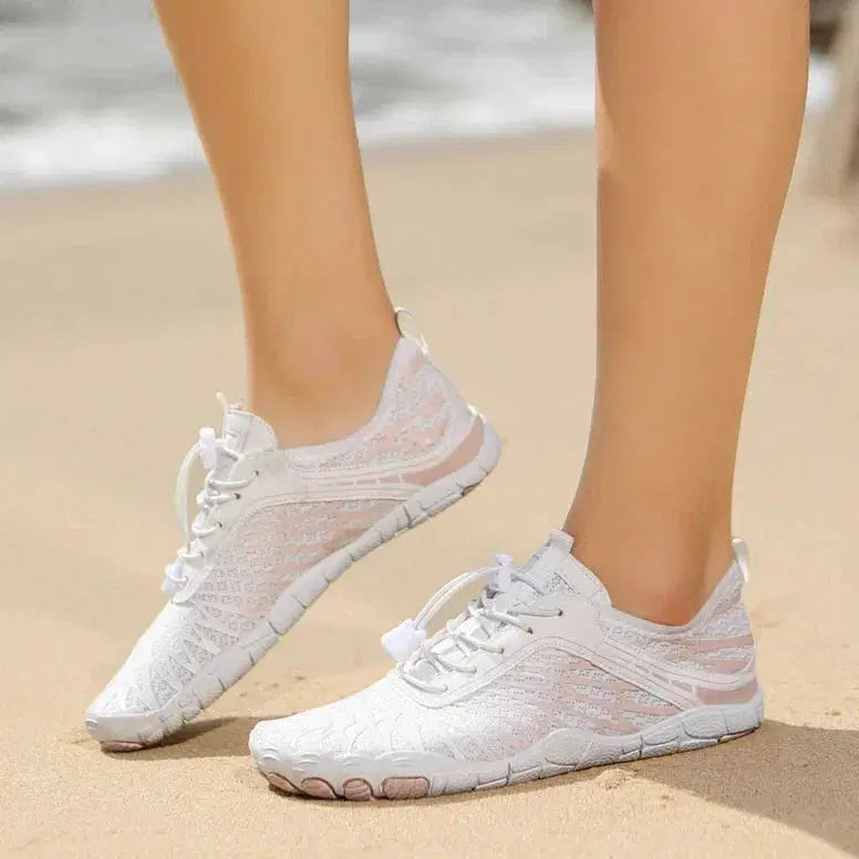 White sneakers on a sandy beach