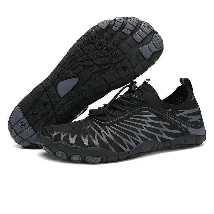 Black and gray athletic shoes with unique sole design on a white background