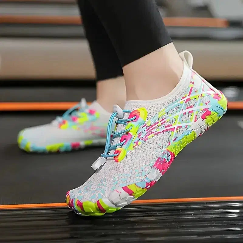 Colorful water shoes on a person's feet with a blurred background