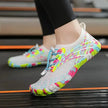 Colorful water shoes on a person's feet with a blurred background