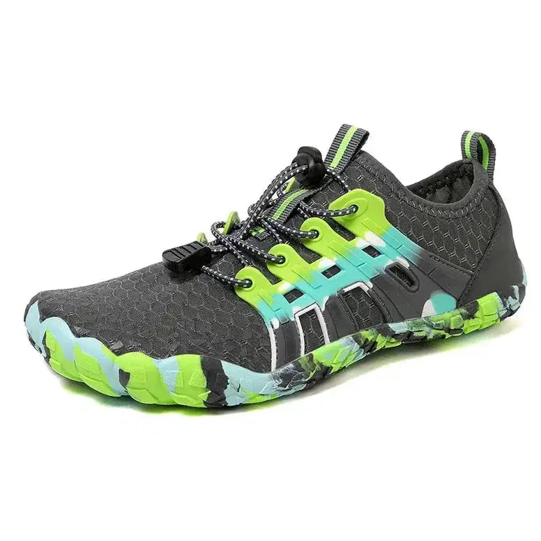 Gray and green athletic shoe on a white background
