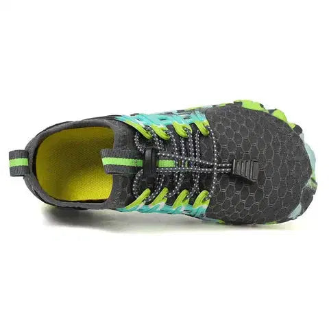 Black and green athletic shoe on a white background