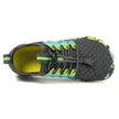 Black and green athletic shoe on a white background