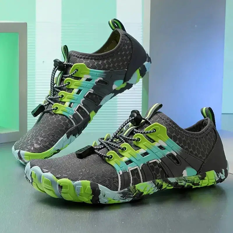 Gray and green athletic shoes on a reflective surface with a light blue and green gradient background