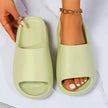 Light green slides with a hand holding one, on a white background