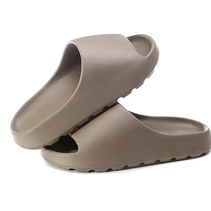 Pair of beige slides on a white background