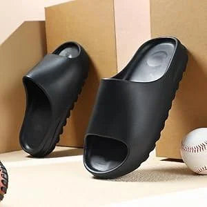 Black slippers on a cardboard box with a baseball in the background