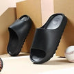 Black slippers on a cardboard box with a baseball in the background