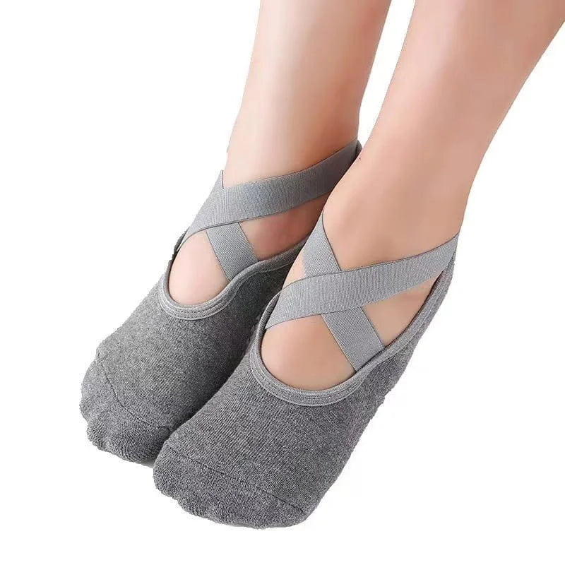Gray ballet-style socks with criss-cross straps on a white background