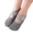 Gray ballet-style socks with criss-cross straps on a white background