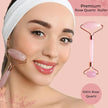 Woman using a rose quartz roller on her face with product details on a pink background