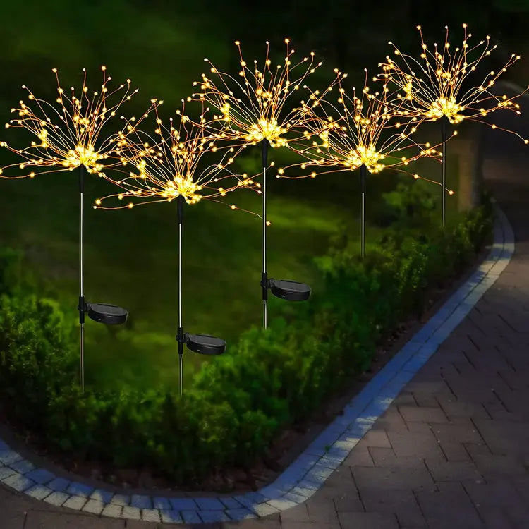 Decorative string lights on stakes in a garden setting