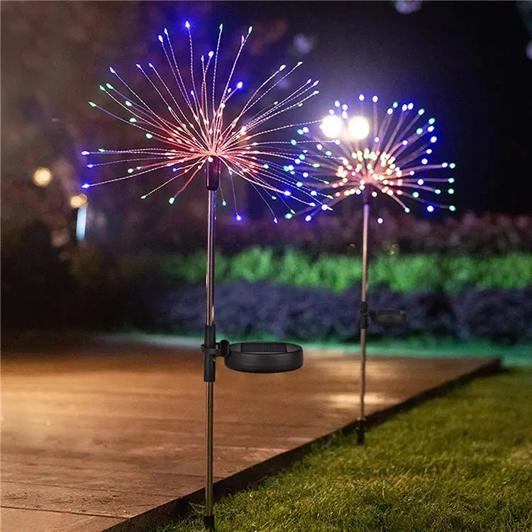 Colorful outdoor light display on a stand in a garden setting