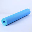 Roll of blue yoga mat on a light gray background