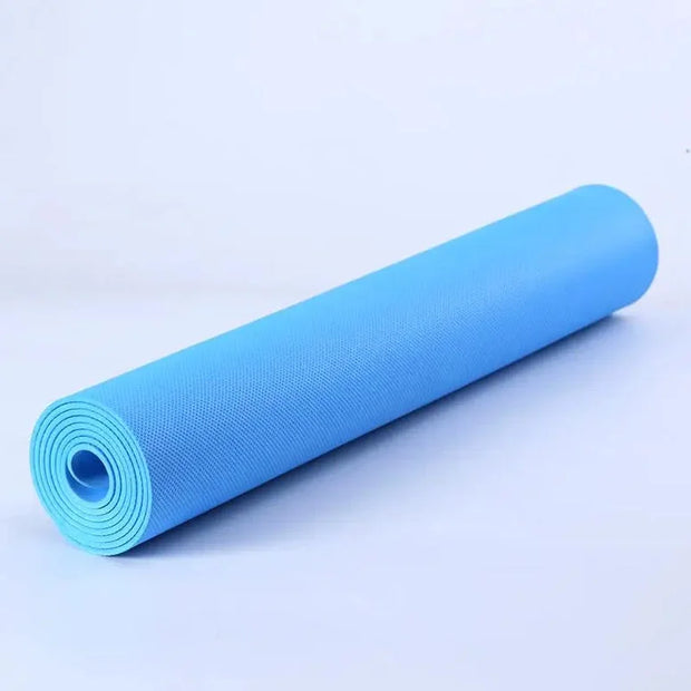 Roll of blue yoga mat on a light gray background