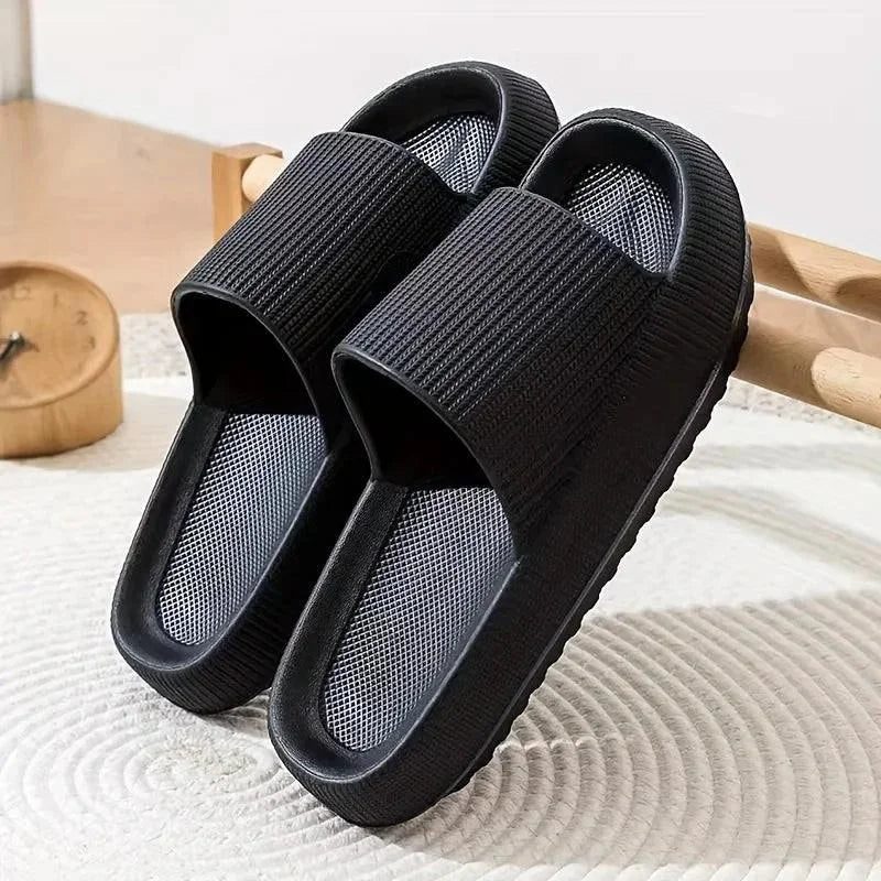 Black slides on a textured surface with a wooden object in the background