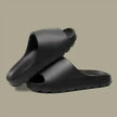 Black rubber slides on a beige background