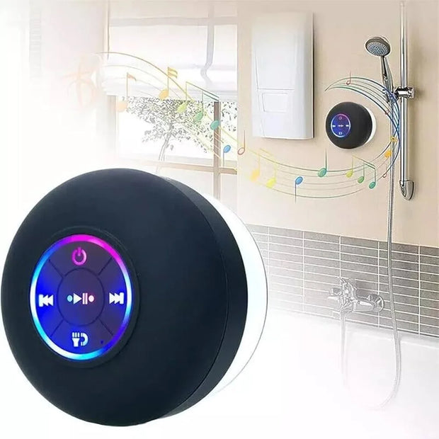 Black Bluetooth speaker with colorful display in a bathroom setting