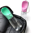 Green pet water bottle and pink travel water bottle with clear liquid on a white background