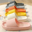 Colorful slippers arranged in a row on a textured surface