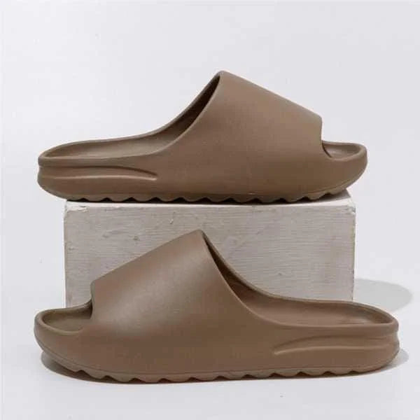 Pair of brown slides on a light gray background