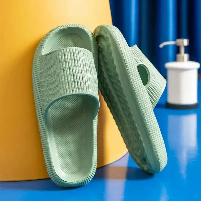 Green slippers on a blue surface with a yellow background