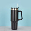 Black insulated travel mug with handle on a light blue background