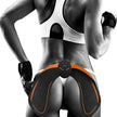 Person using a black and orange EMS muscle stimulator device.
