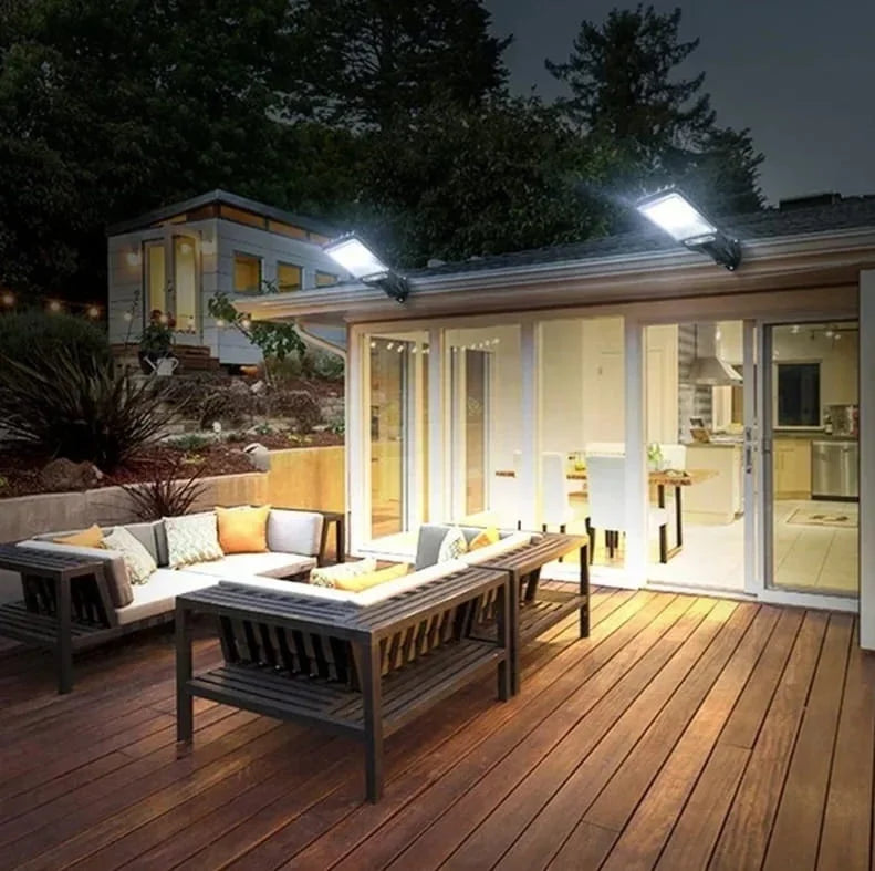 Evening view of a modern house with outdoor deck and furniture