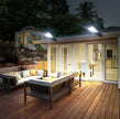 Evening view of a modern house with outdoor deck and furniture
