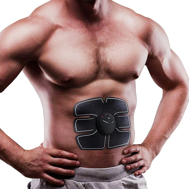 Man wearing an abdominal muscle stimulator device on a white background