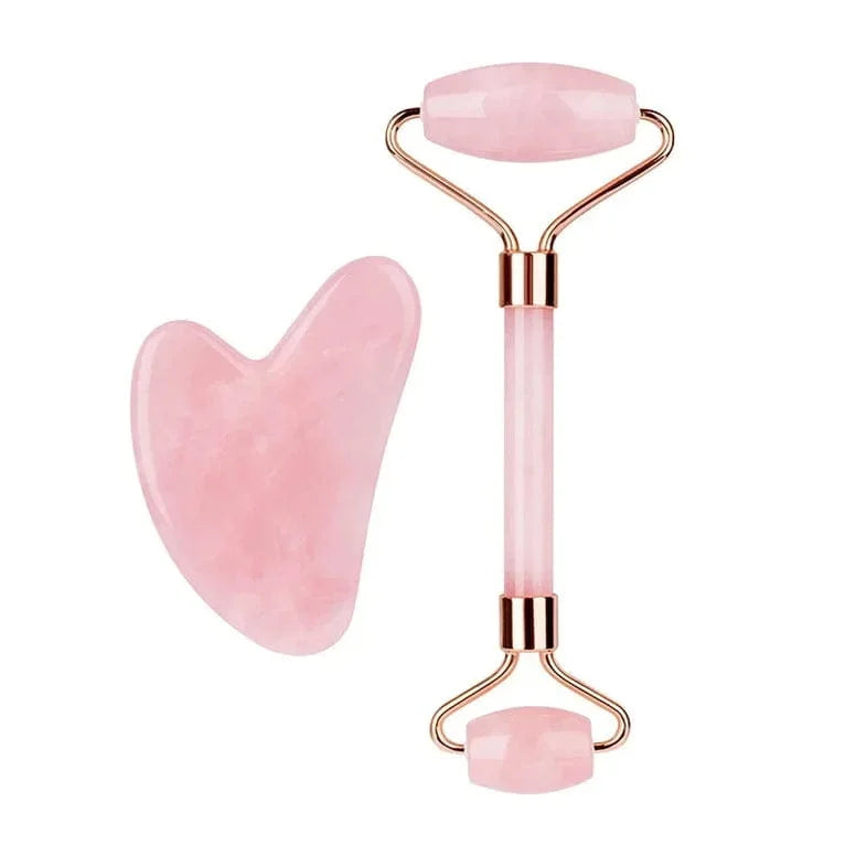 Pink jade roller and gua sha tool on a white background