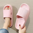 Pink slippers worn with a neutral background