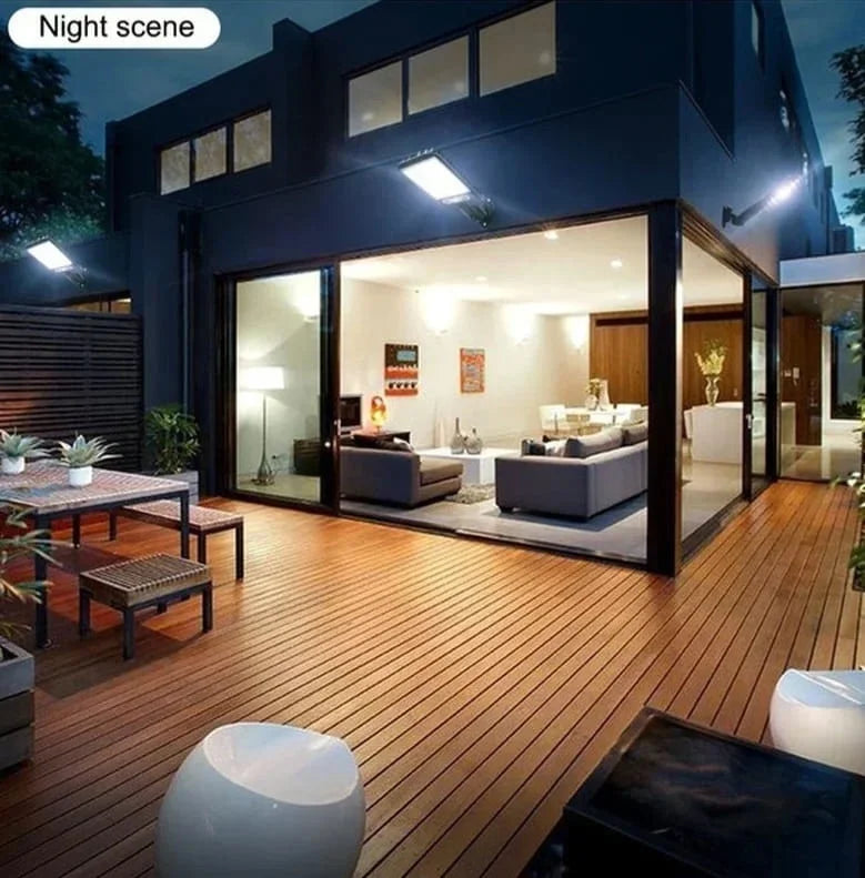 Modern house with a wooden deck and open patio area at night.