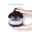 Hand lifting the cover of a dark brown diffuser on a white background