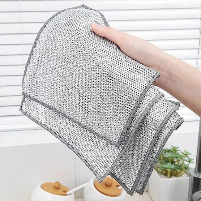 Person holding a gray mesh cleaning cloth with a white background