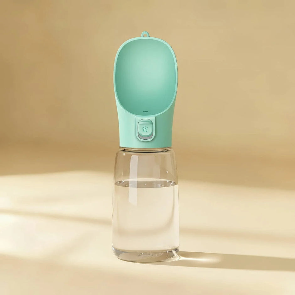 Portable water bottle with a green lid on a beige background