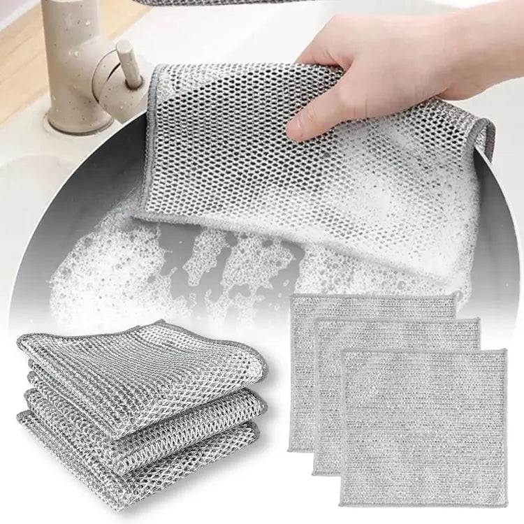 Gray mesh scrubber being used in a sink with additional scrubbers stacked nearby.