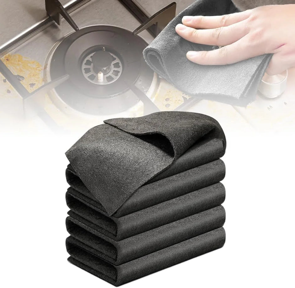 Stack of gray cleaning cloths with a hand using one on a kitchen stove.