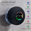 Shower speaker with RGB lights and waterproof features on a wet surface